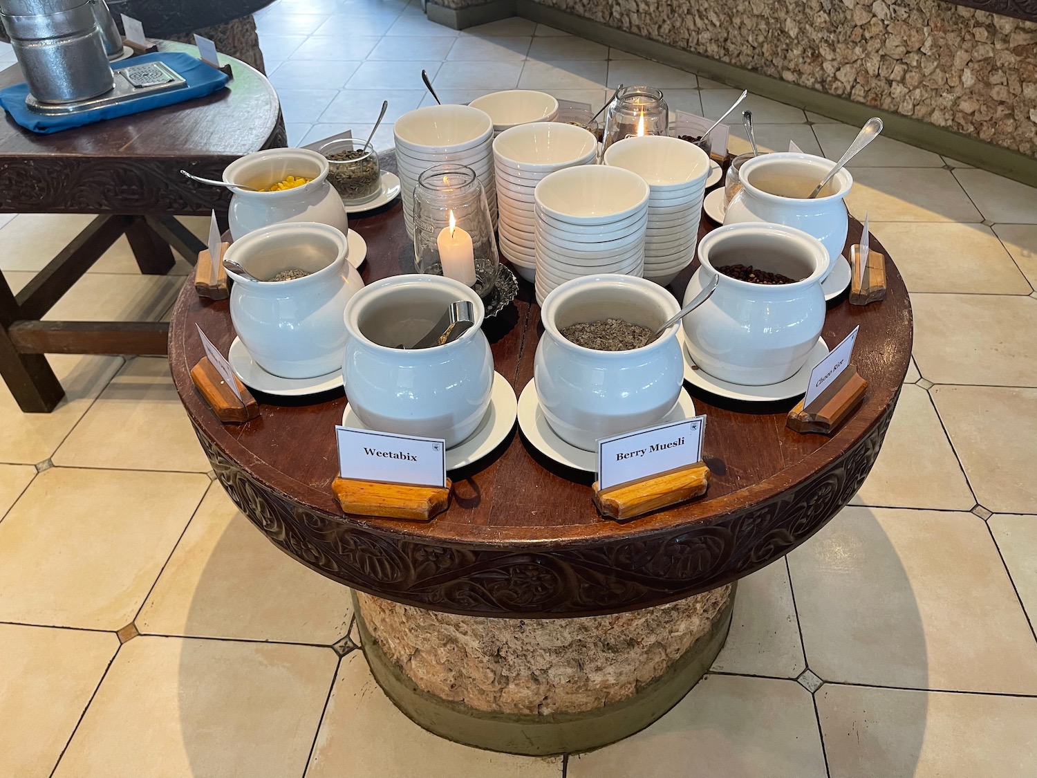 a table with white bowls and spoons on it