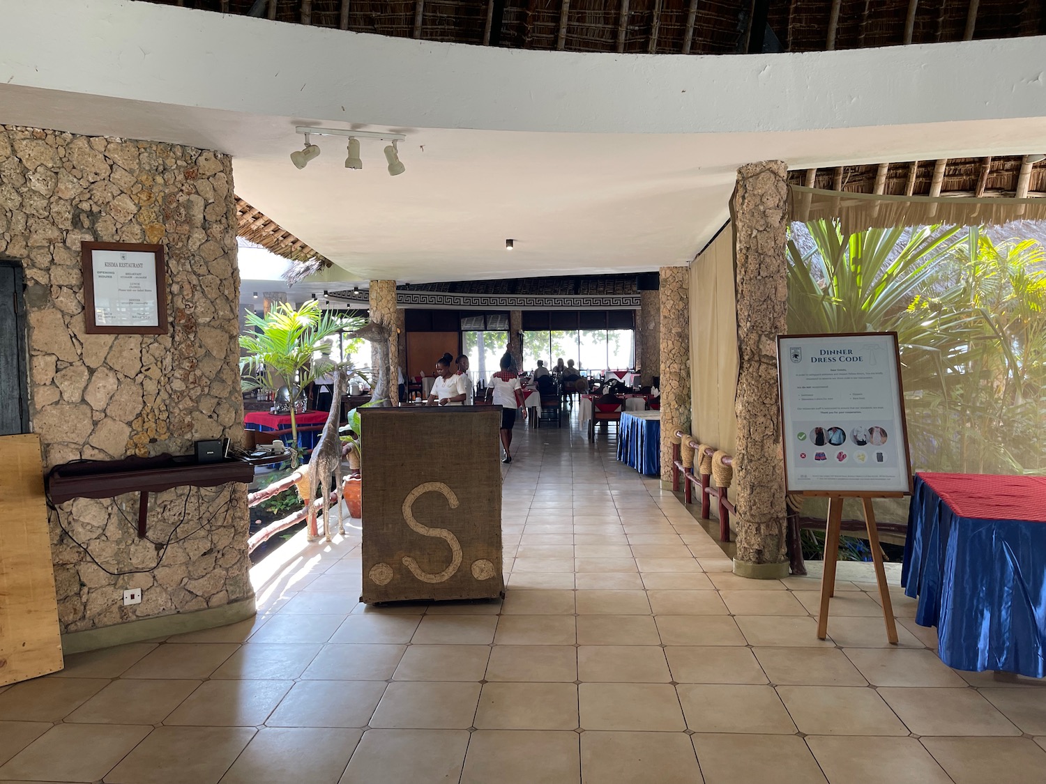 a room with stone pillars and a sign