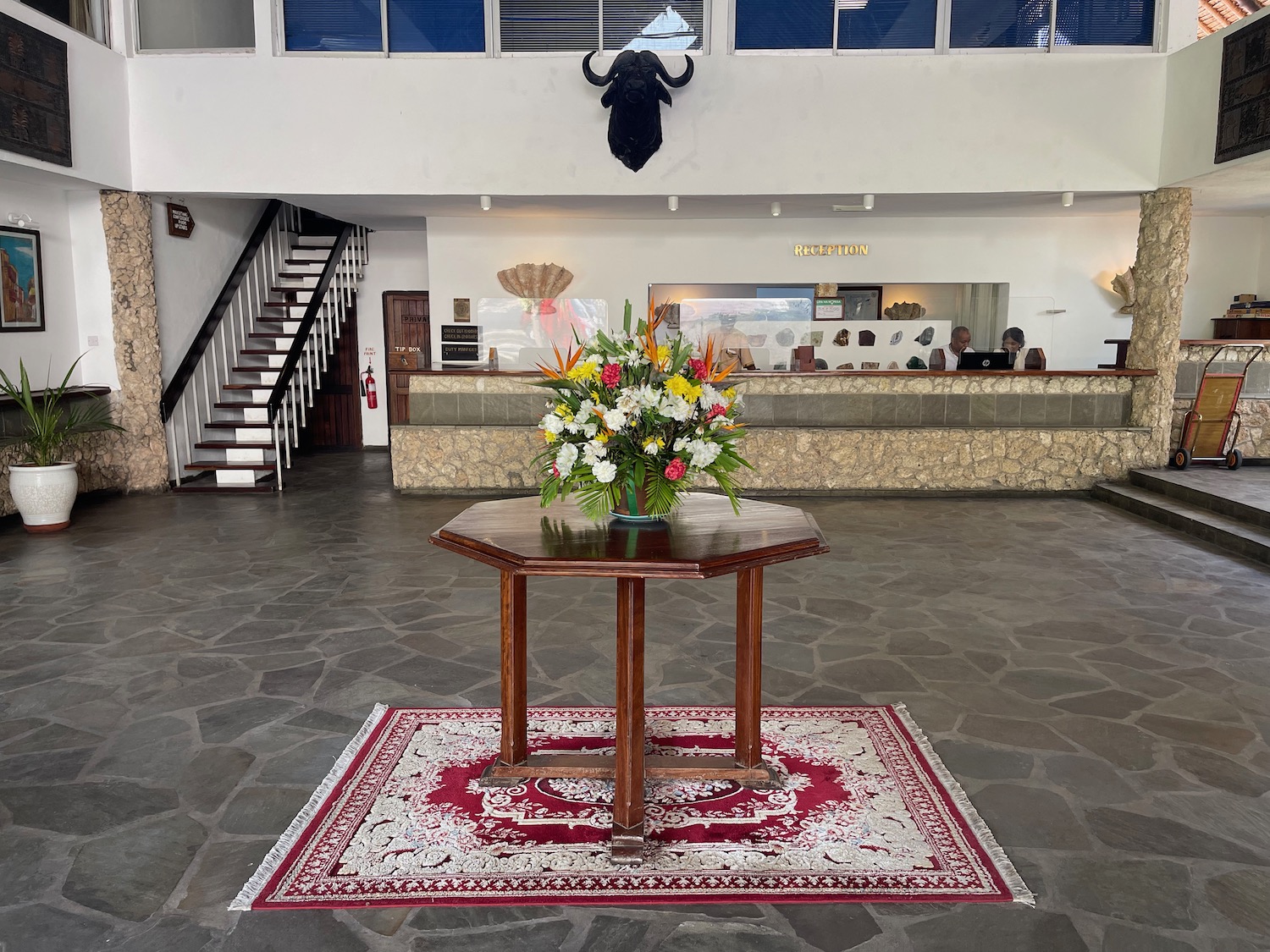 a table with flowers on it in a lobby