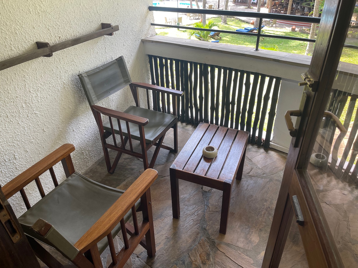 a patio with chairs and a table