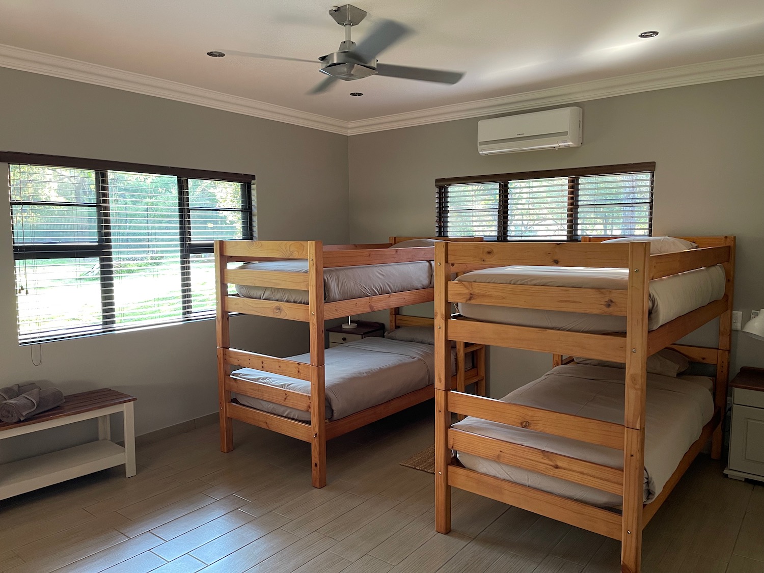 a room with bunk beds and a fan