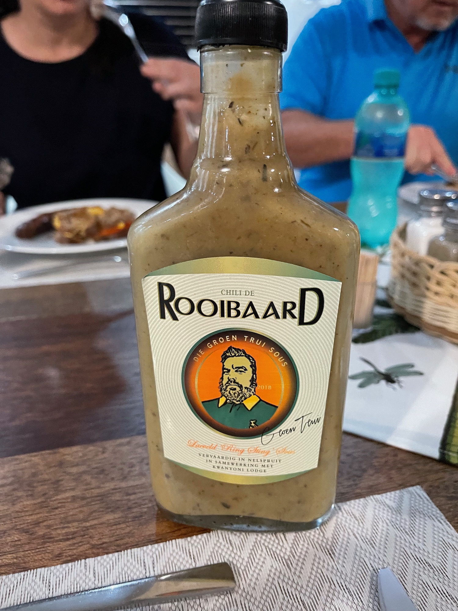 a bottle of hot sauce on a table