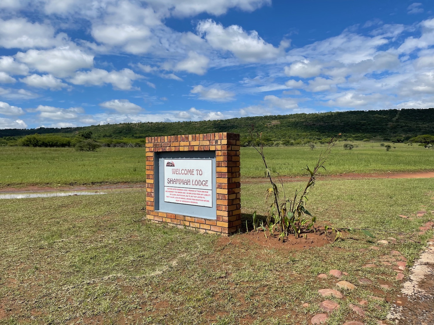 a sign in a grassy field