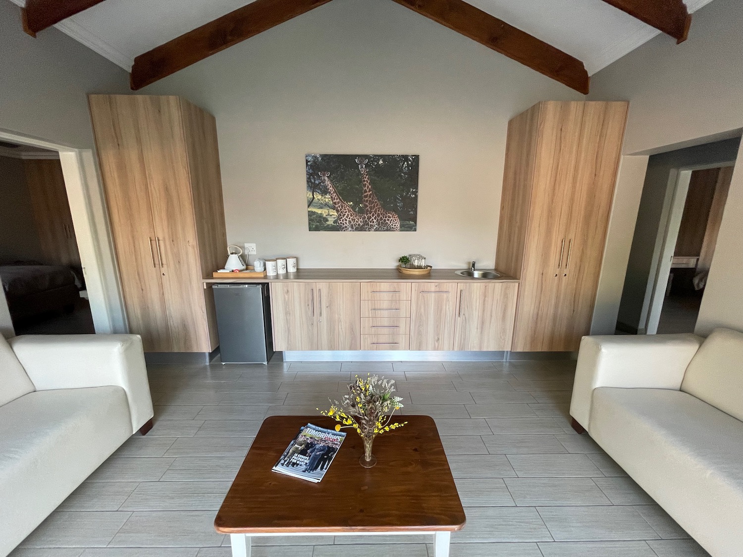 a room with a wood table and white furniture