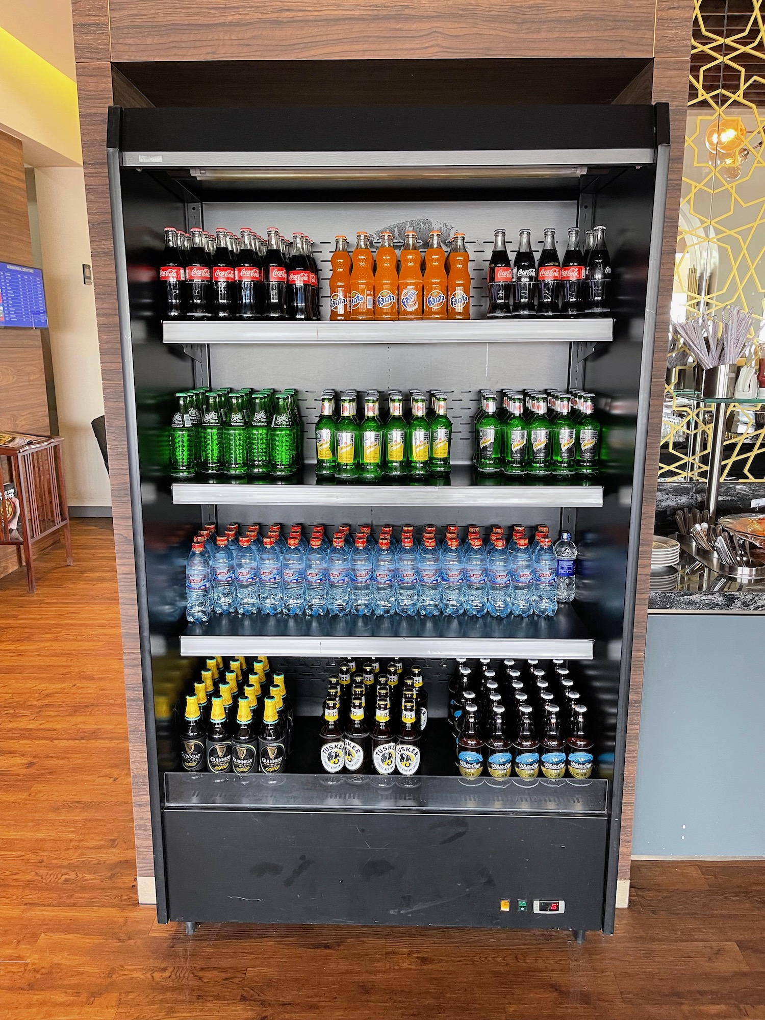 a shelf with bottles of soda and water