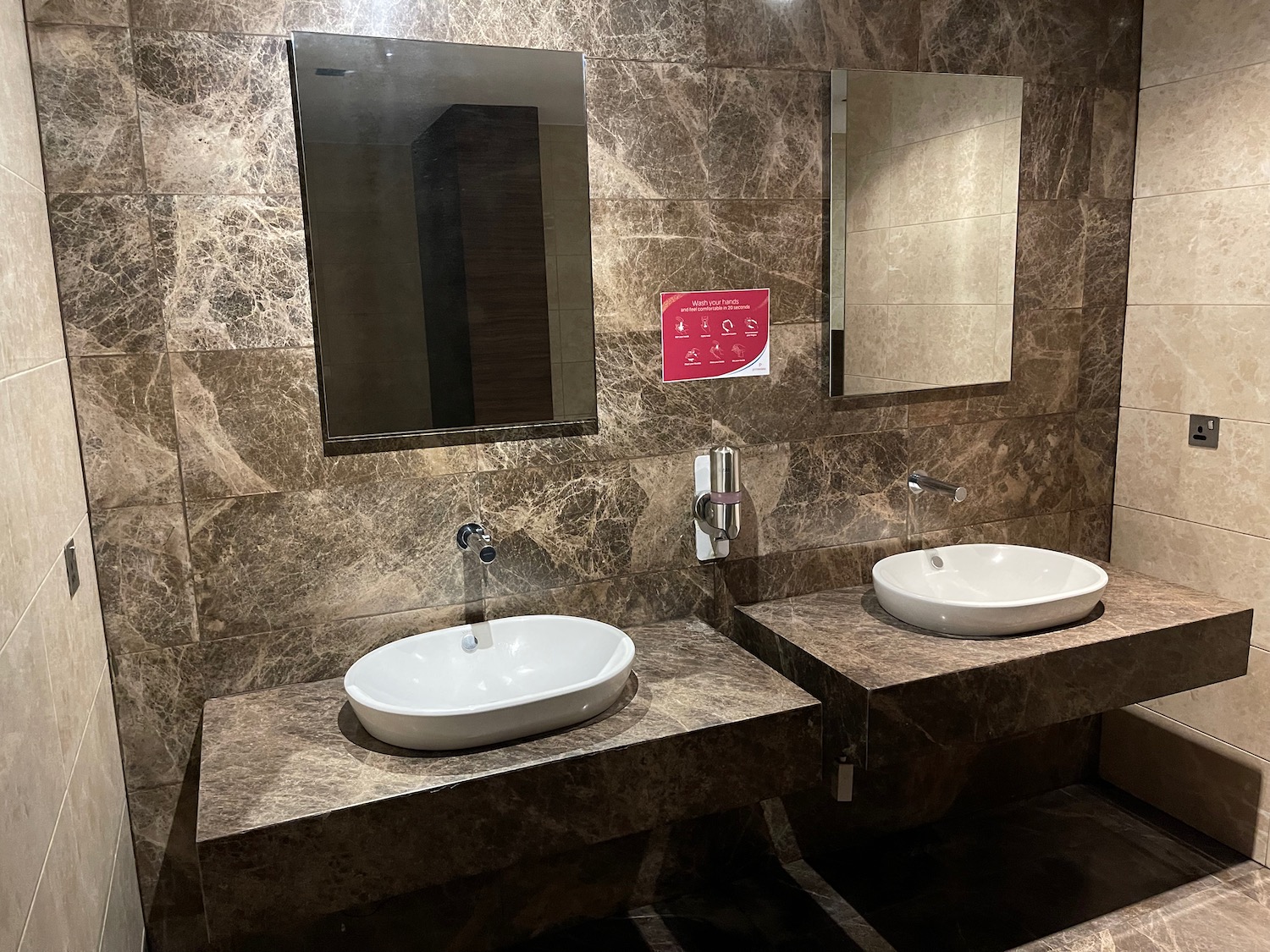 a bathroom with sinks and mirrors