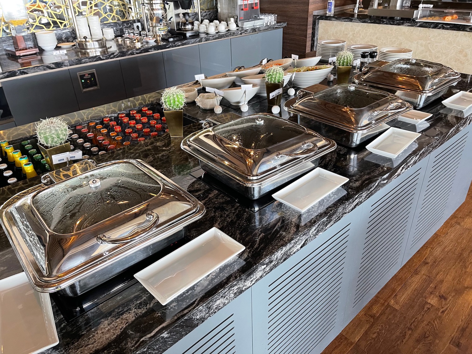 a buffet line with silver containers