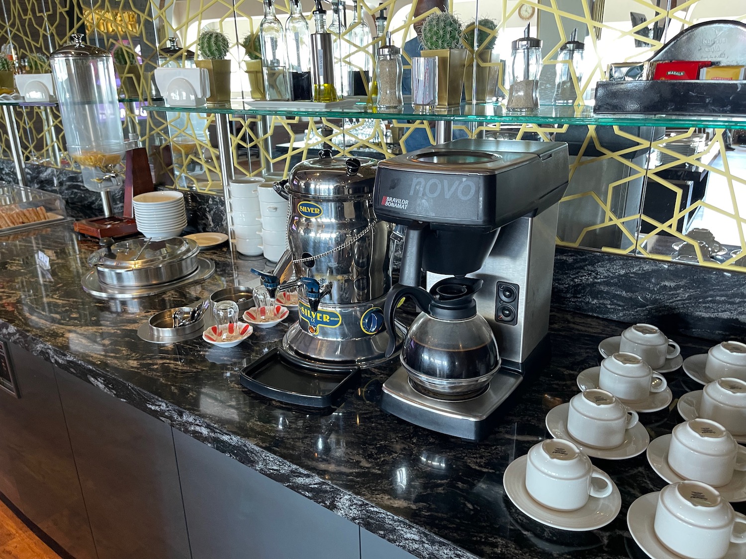 a coffee maker and cups on a counter