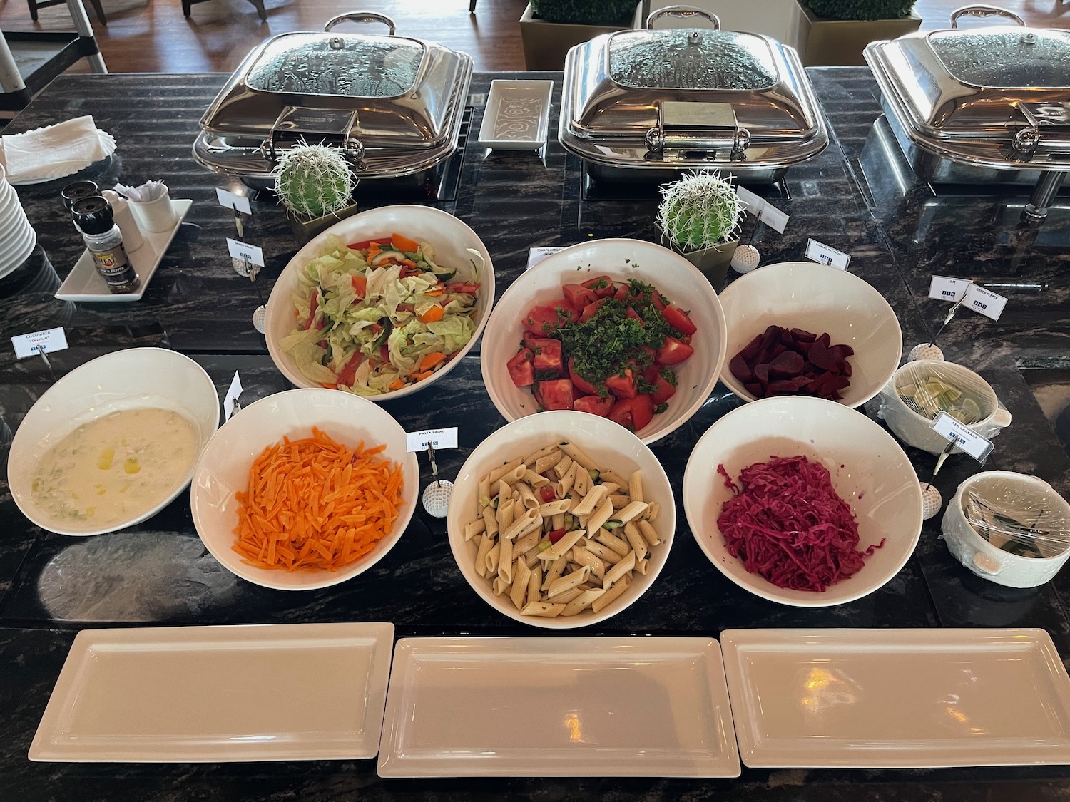 a buffet table with bowls of food