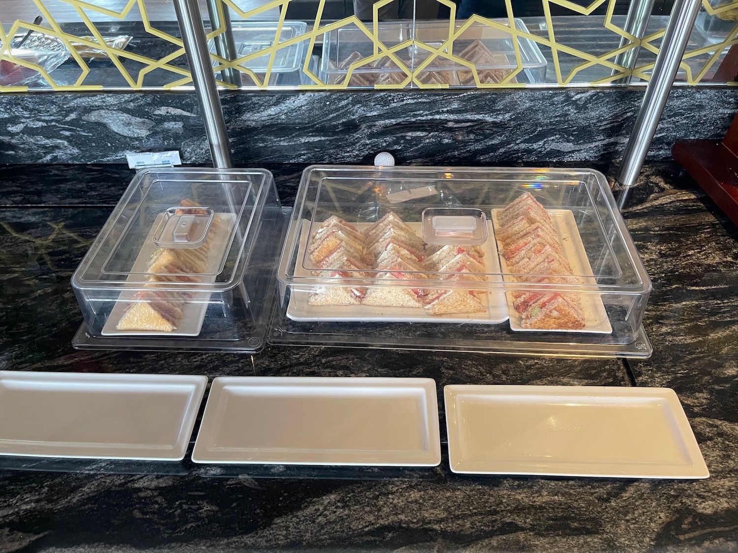 a trays of sandwiches in plastic containers