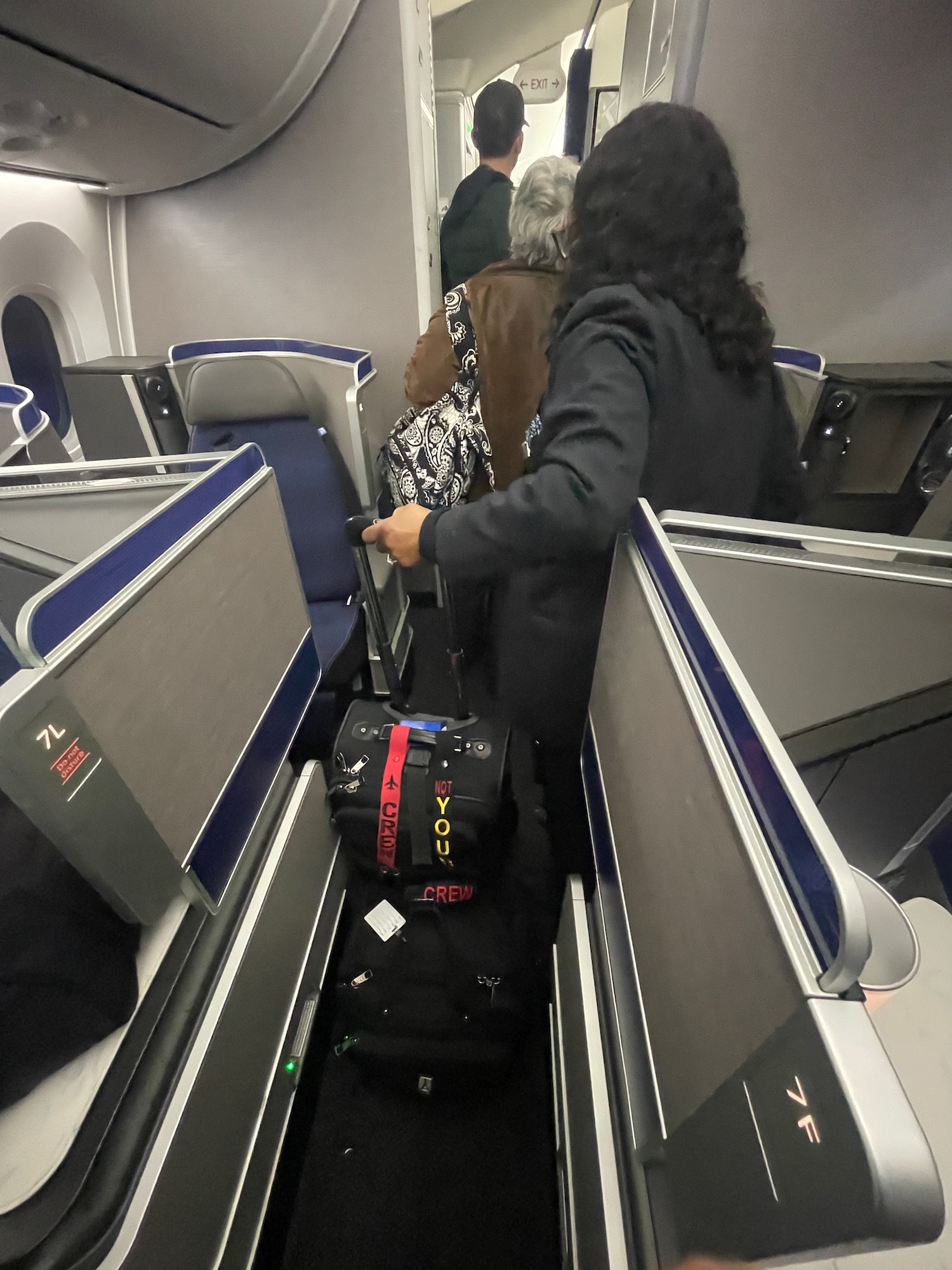 people on an airplane with luggage