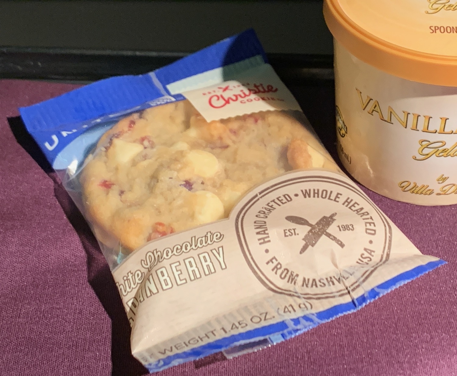 a bag of cookies next to a cup of coffee