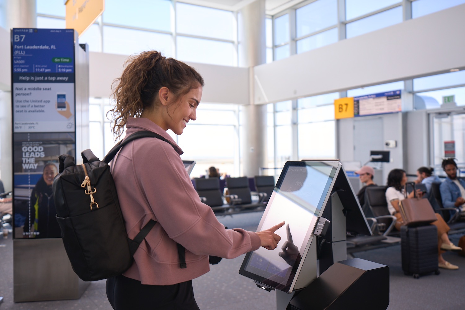 a woman using a touch screen device