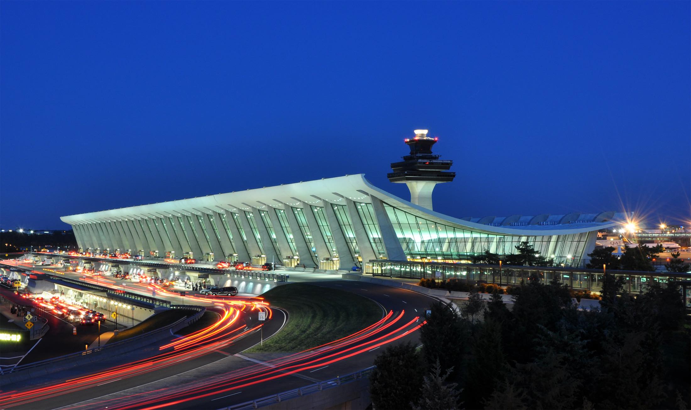 a large airport with a tower and a traffic light