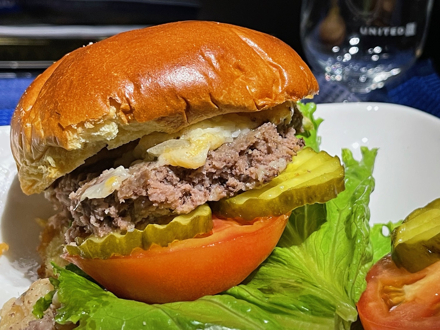 a burger with lettuce and tomato on a plate