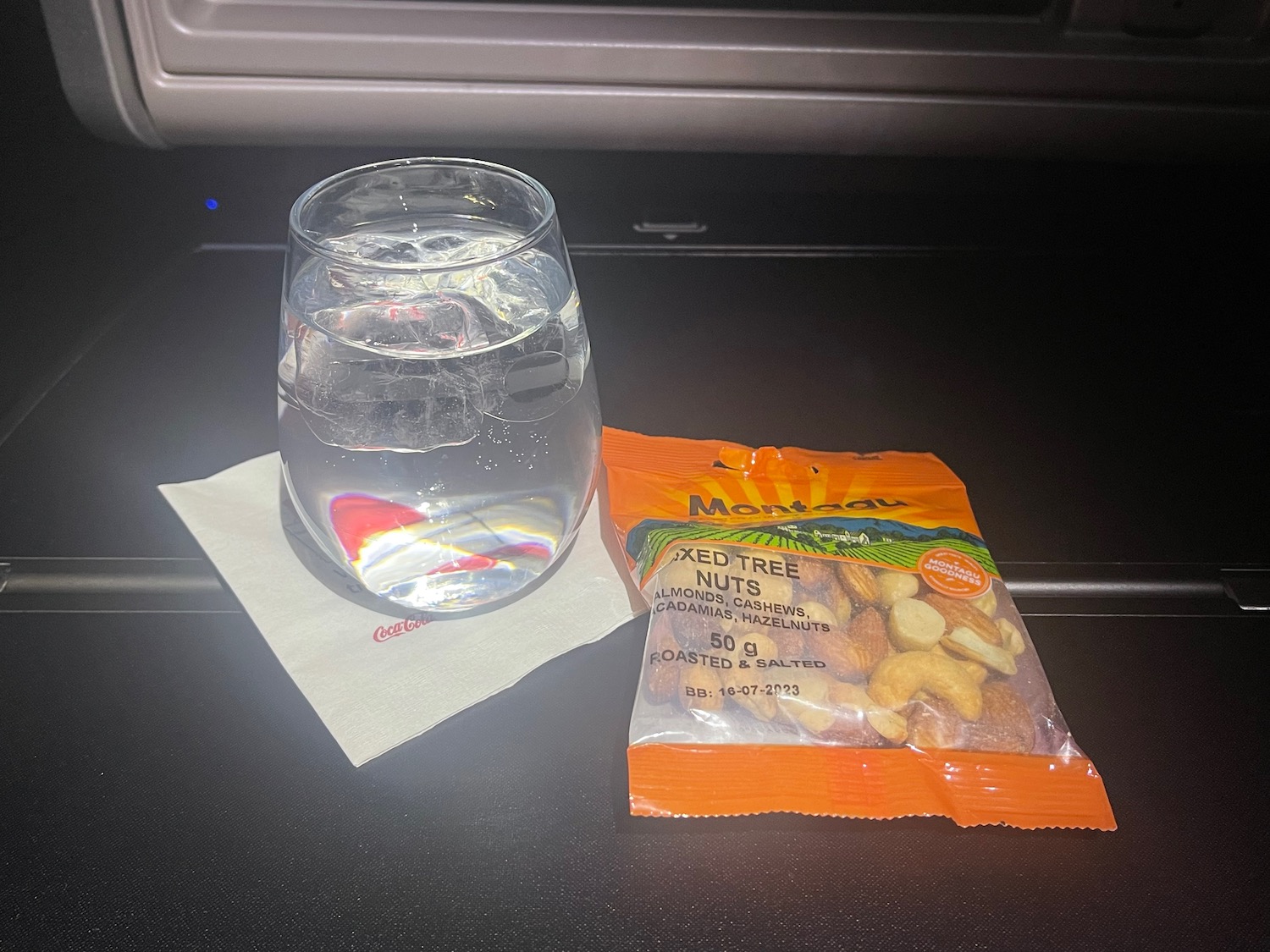 a glass of water and a bag of nuts