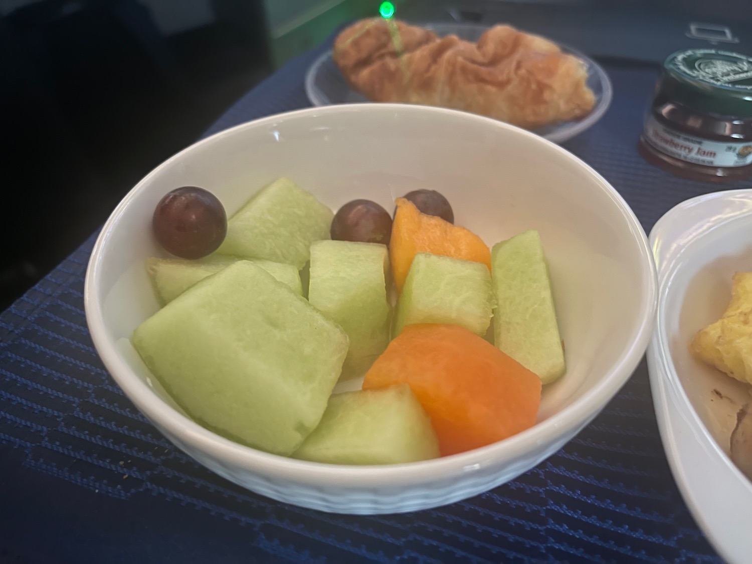 a bowl of fruit on a table