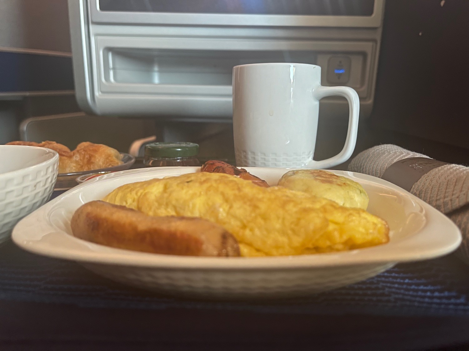 a plate of food and a mug on a table