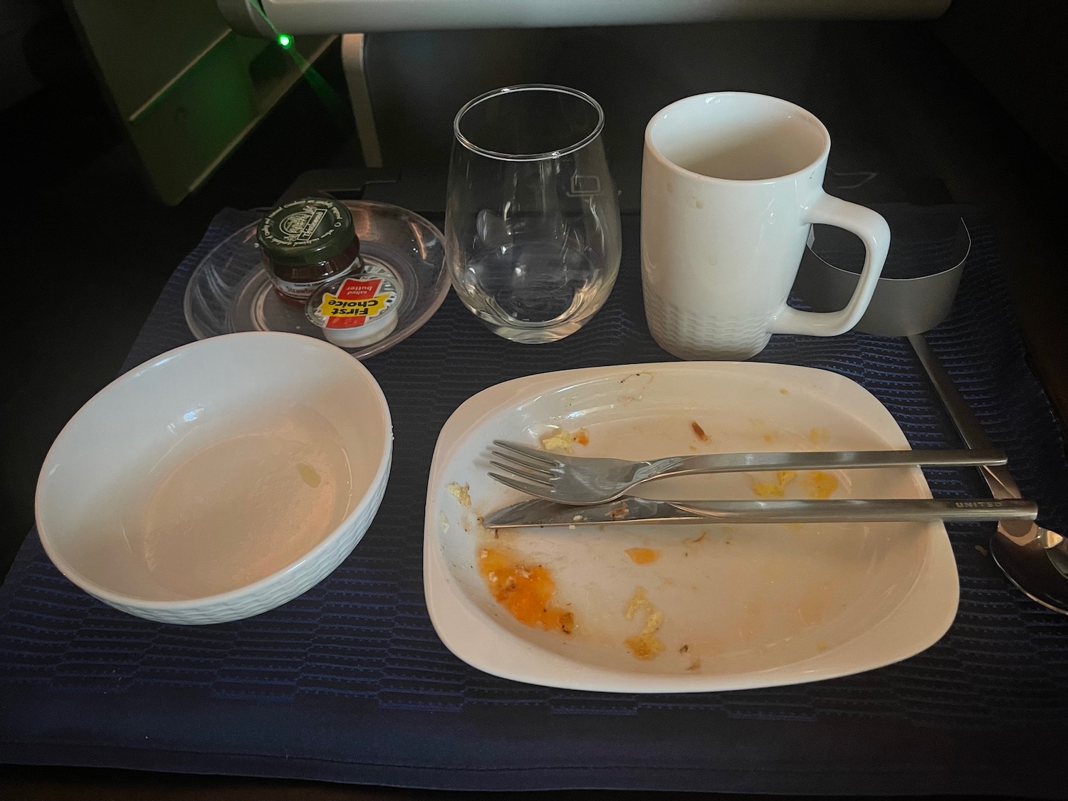 a plate with food and utensils on a table