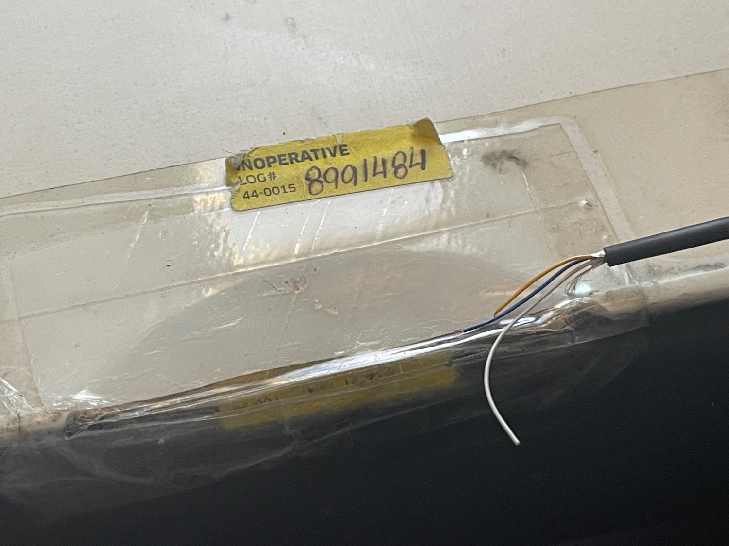 a plastic wrap with a yellow label and wires