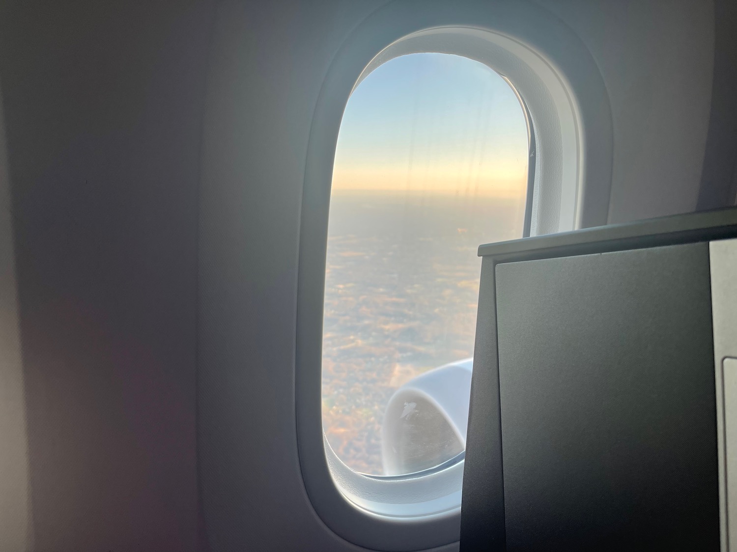 an airplane window with a view of the sky