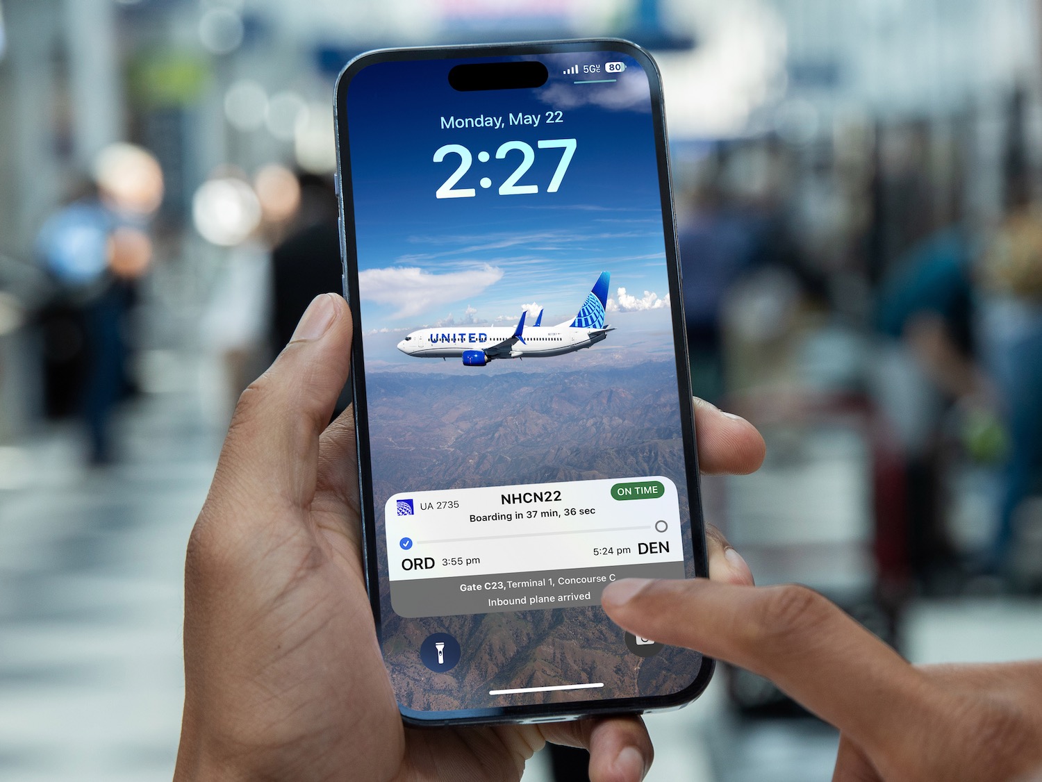a hand holding a phone with a screen showing an airplane