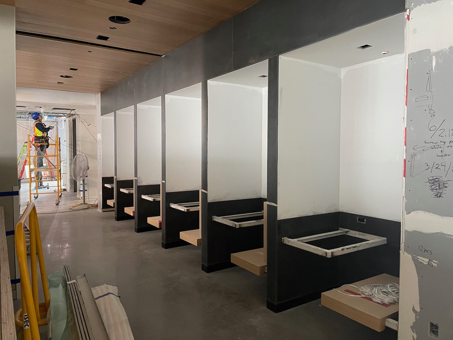 a row of white and black walls with wooden shelves