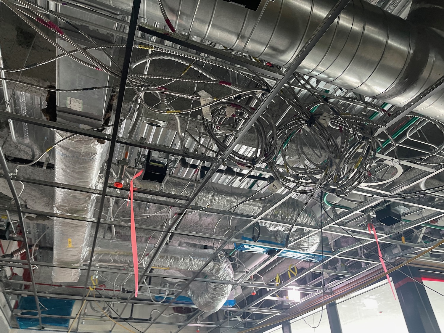 a ceiling with pipes and wires