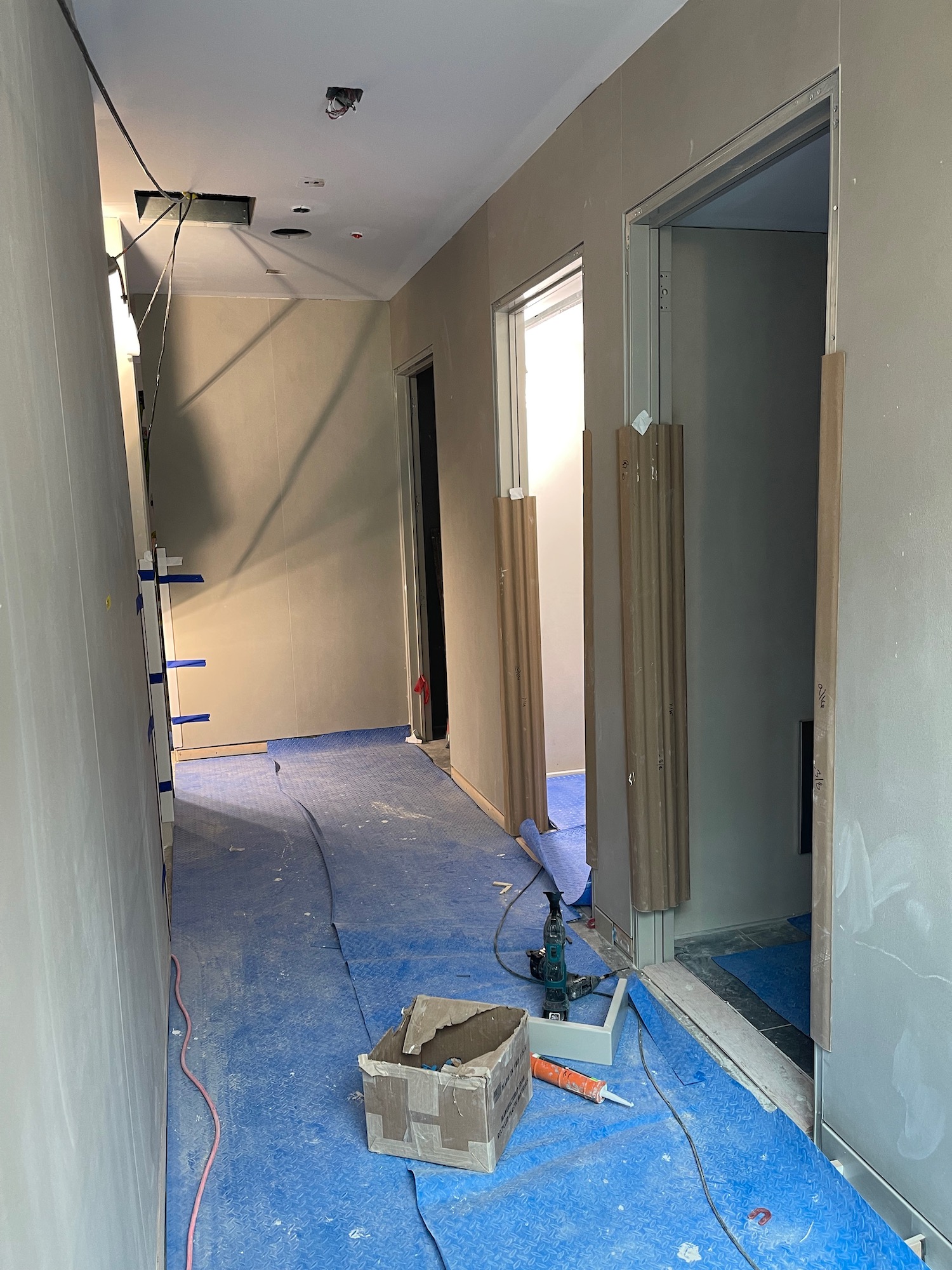 a hallway with blue flooring and blue carpet