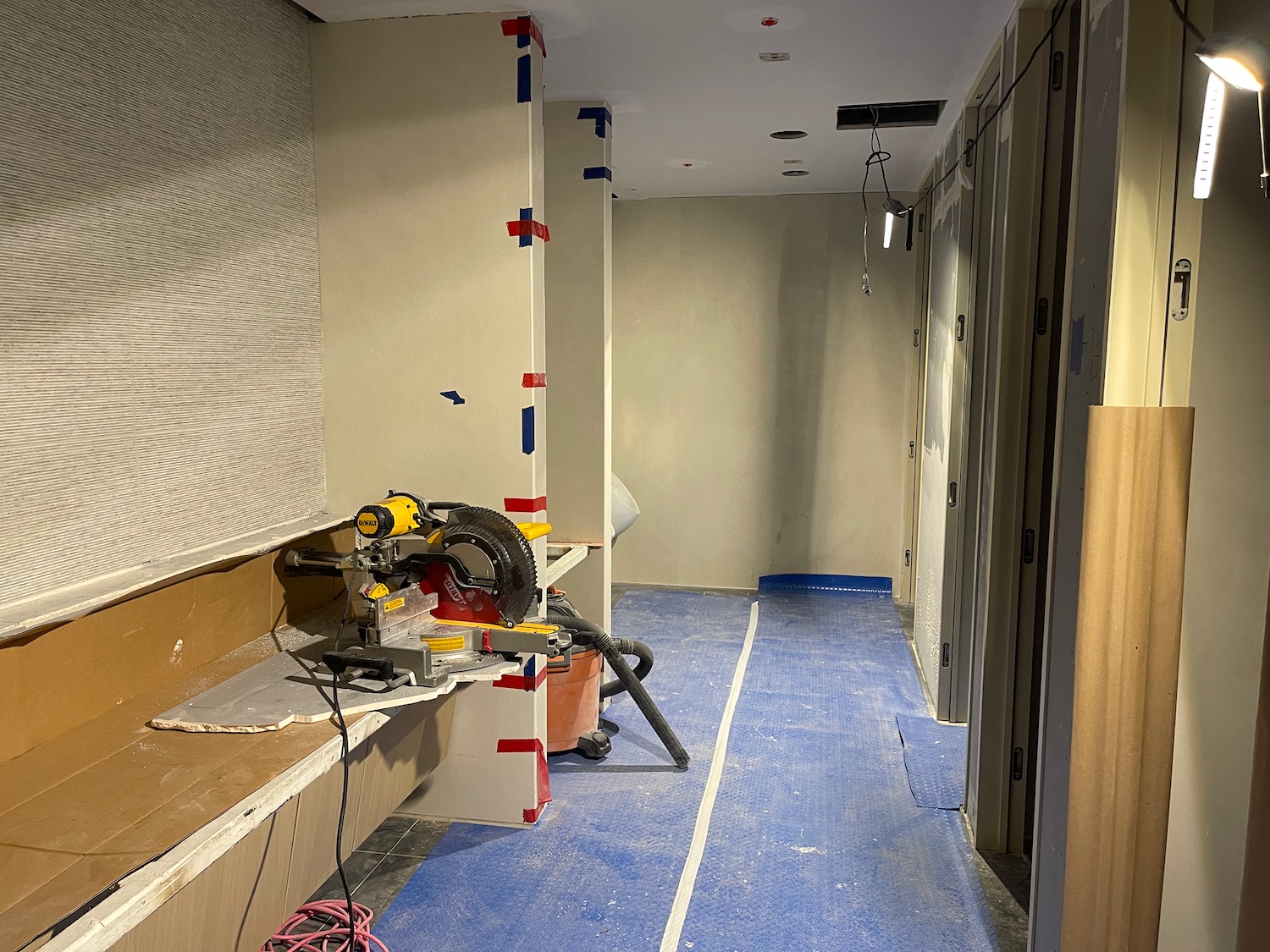 a room with a circular saw and a blue floor