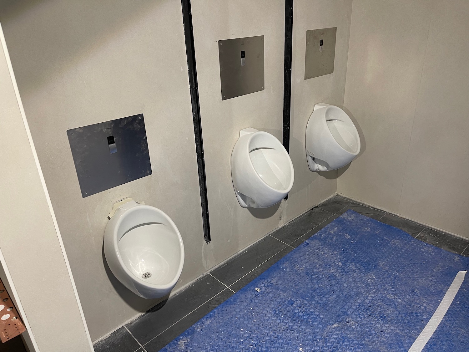 a row of urinals in a bathroom