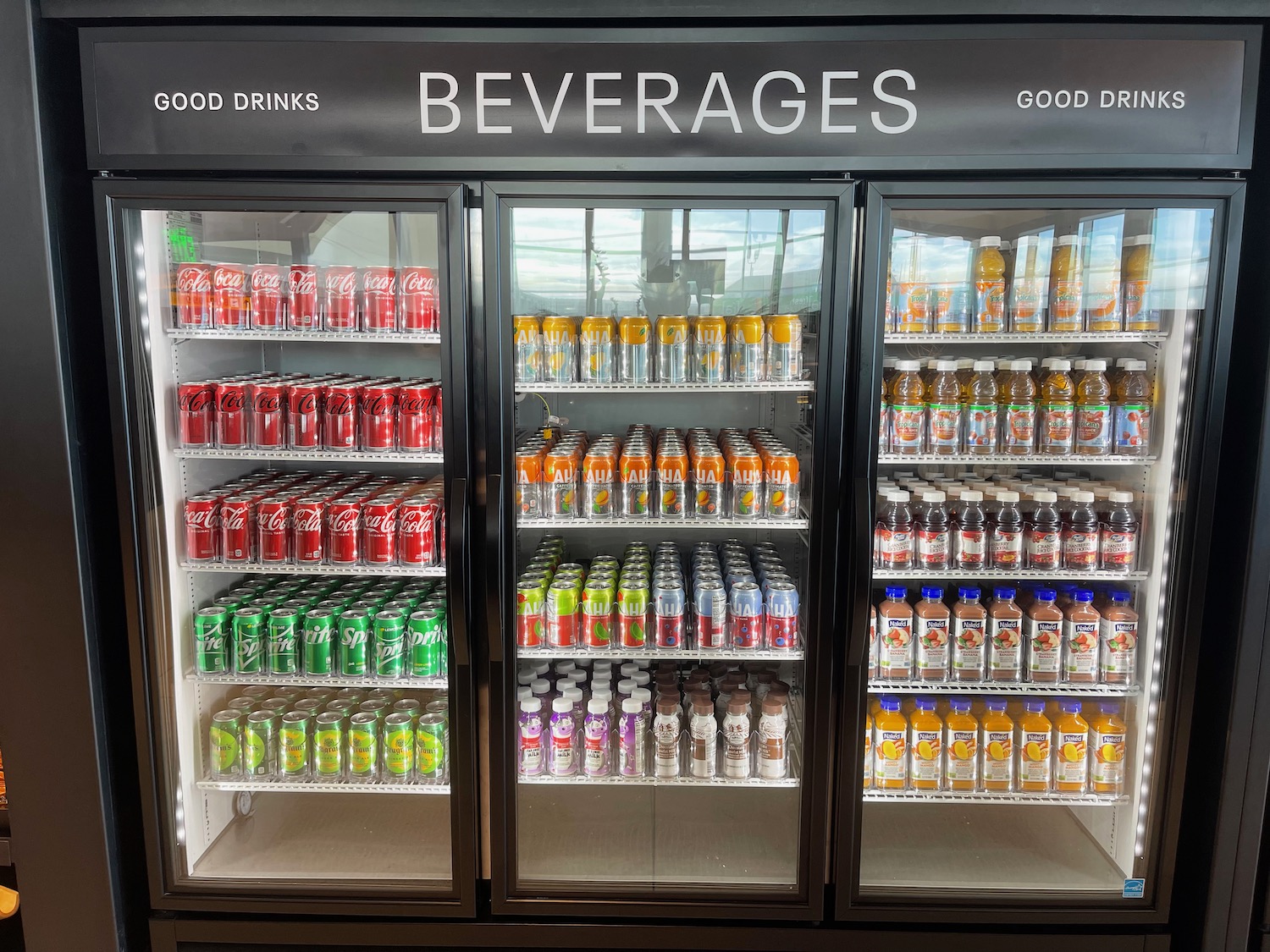 a cooler with drinks on shelves