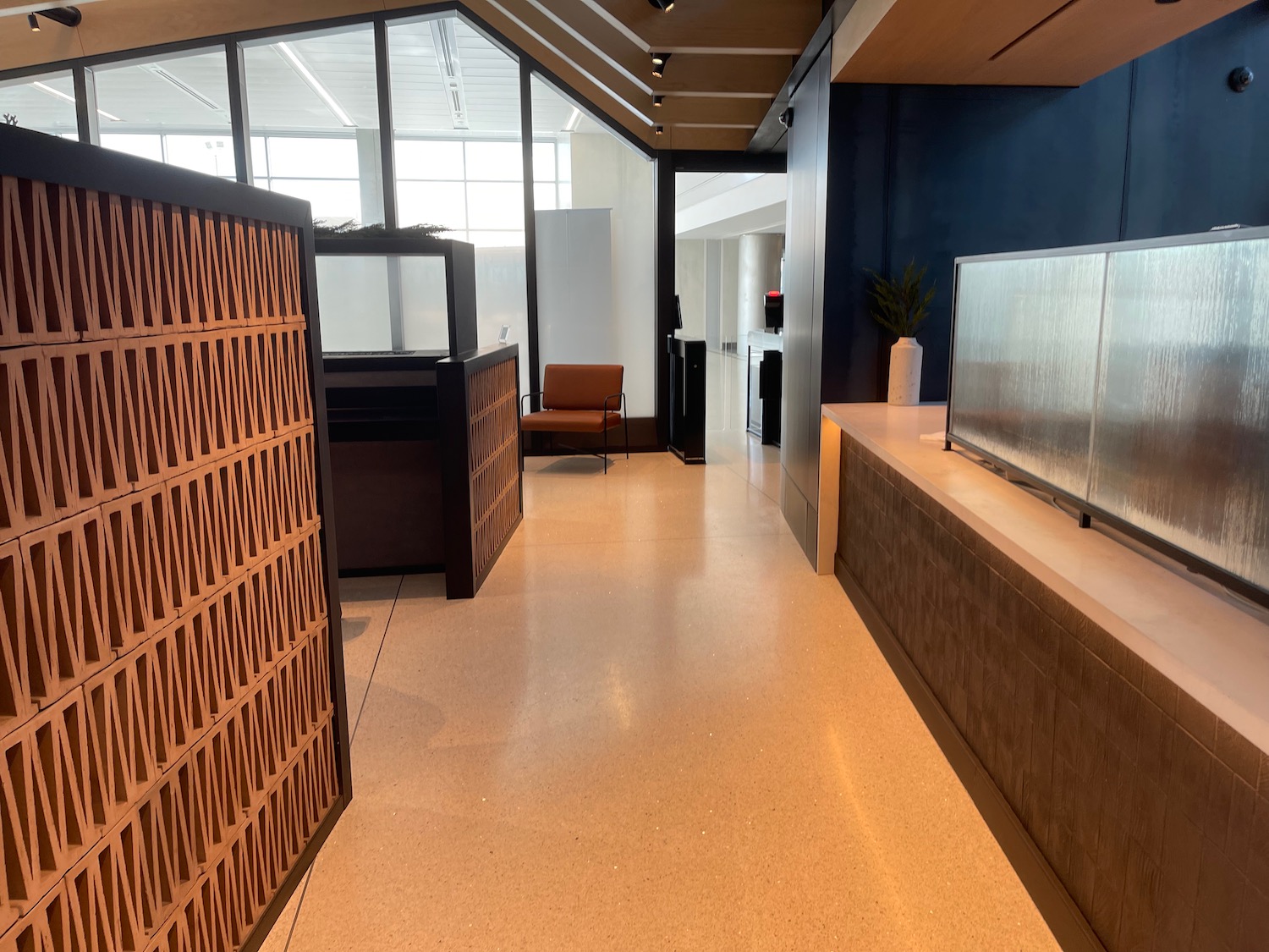 a hallway with a tv and a screen