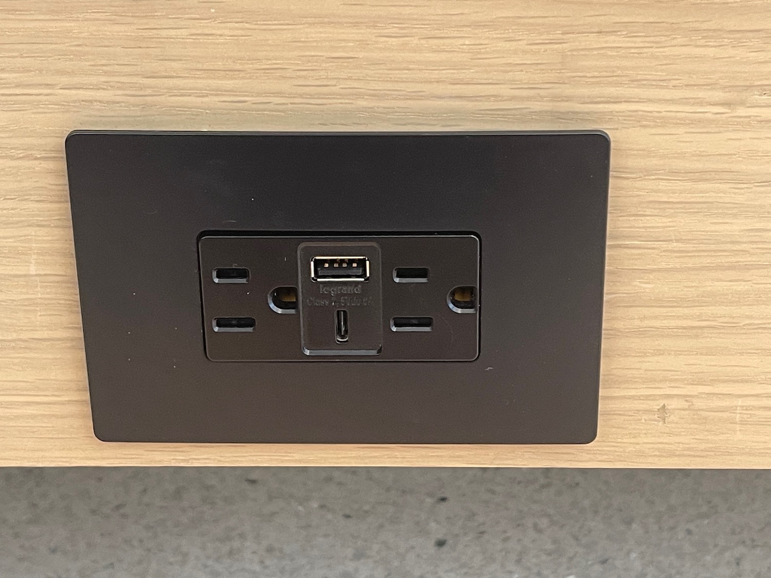 a black outlet on a wood surface