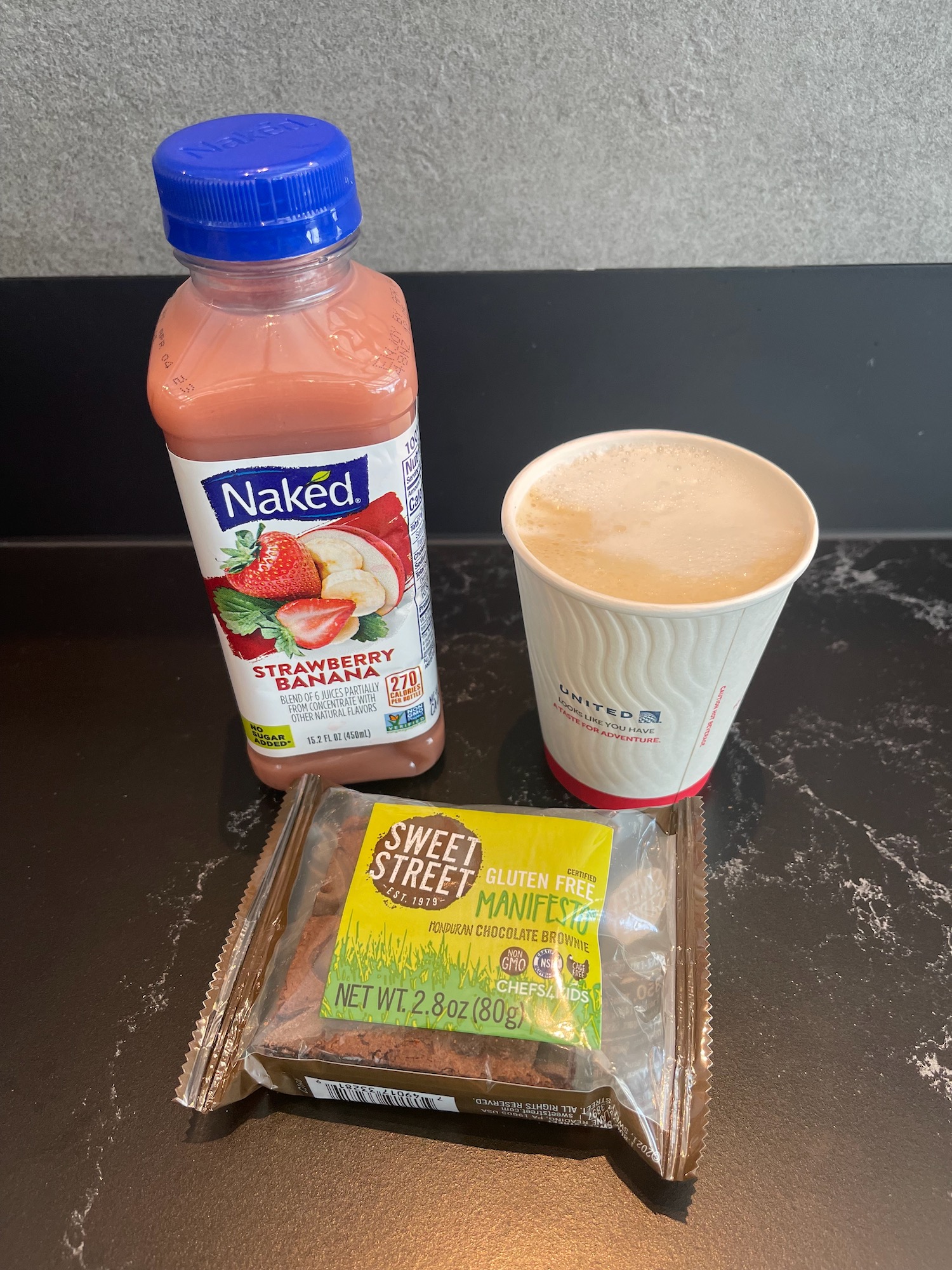 a drink and a package of brownies on a counter