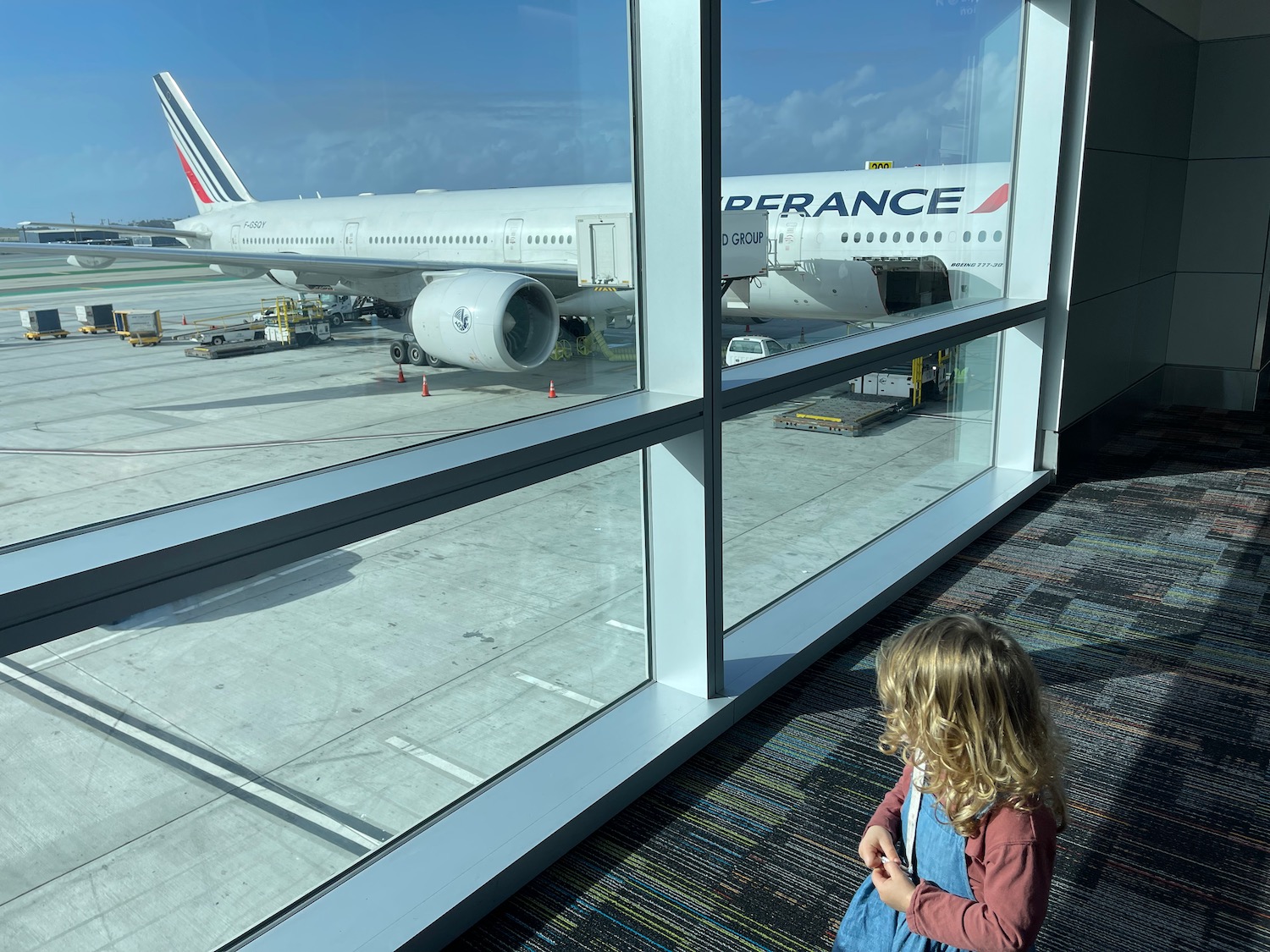 a girl looking at an airplane