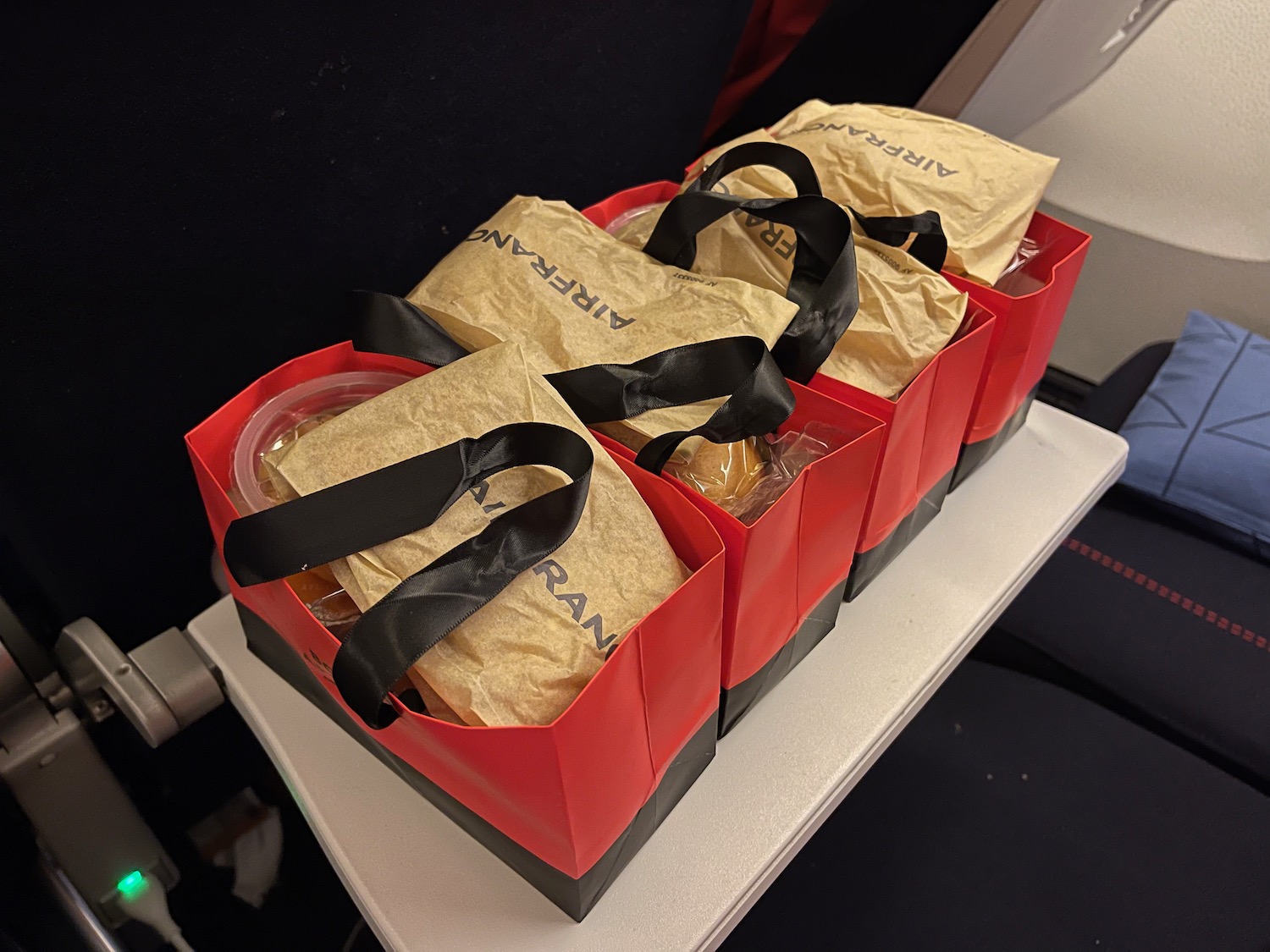 a group of red and black bags with food in them