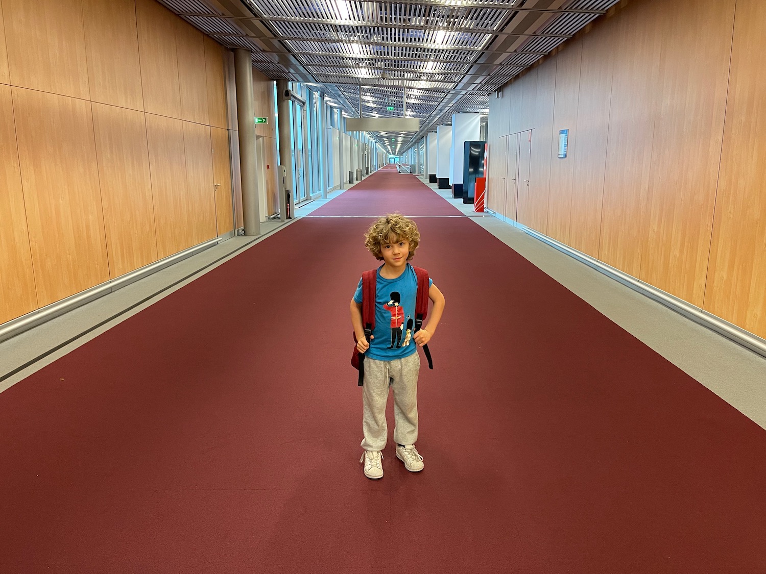 a boy standing in a hallway