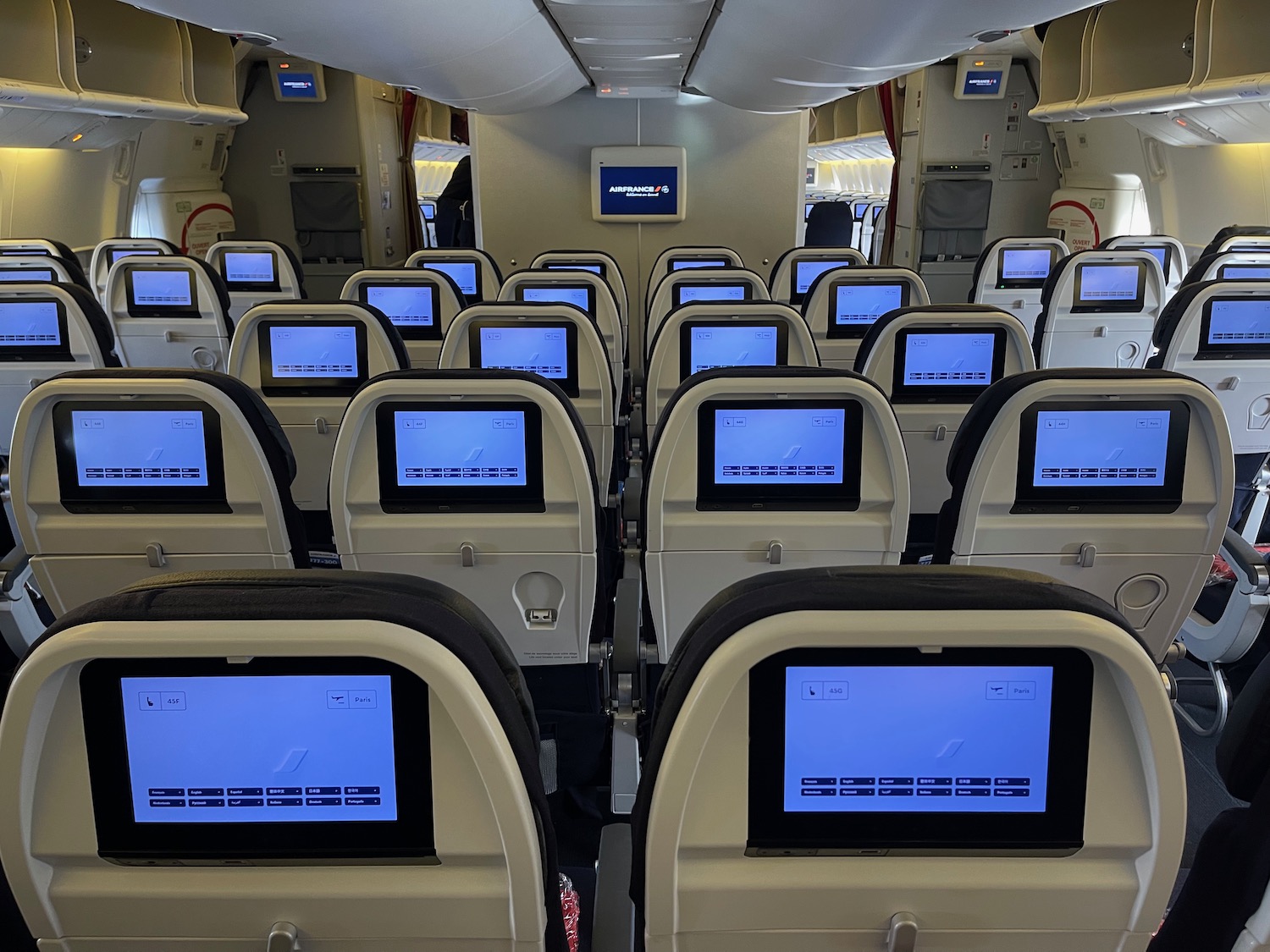 a row of seats with monitors on the back