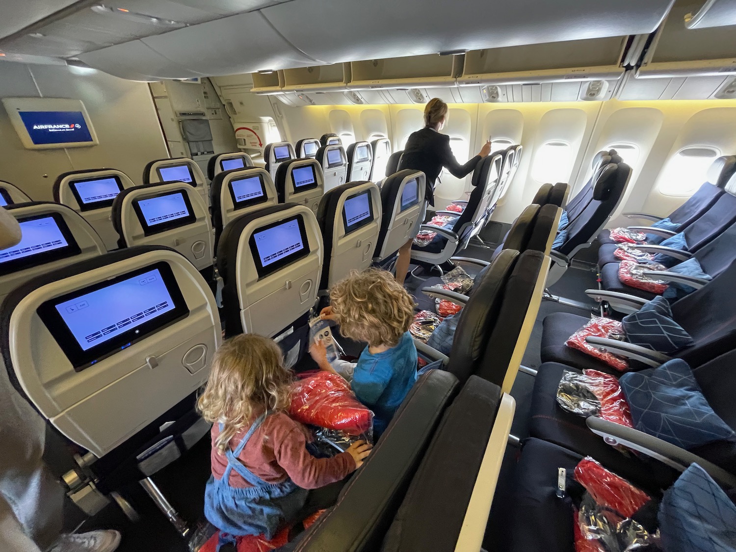 a group of children sitting in an airplane