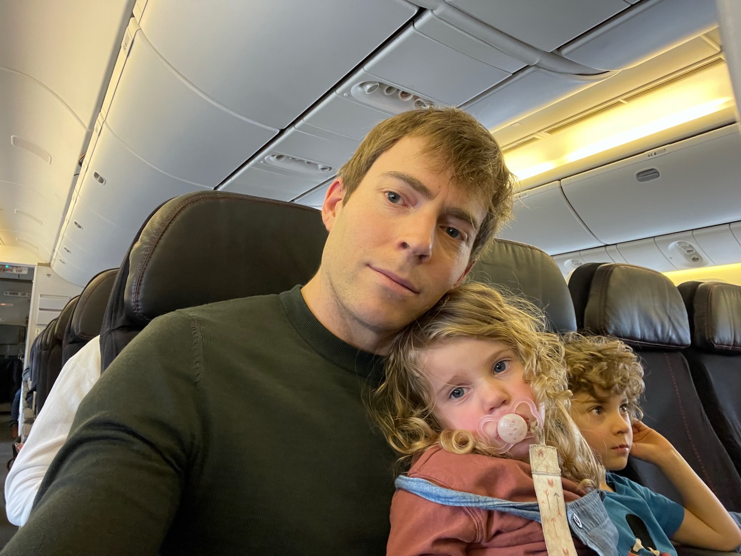 a man taking a selfie with two children