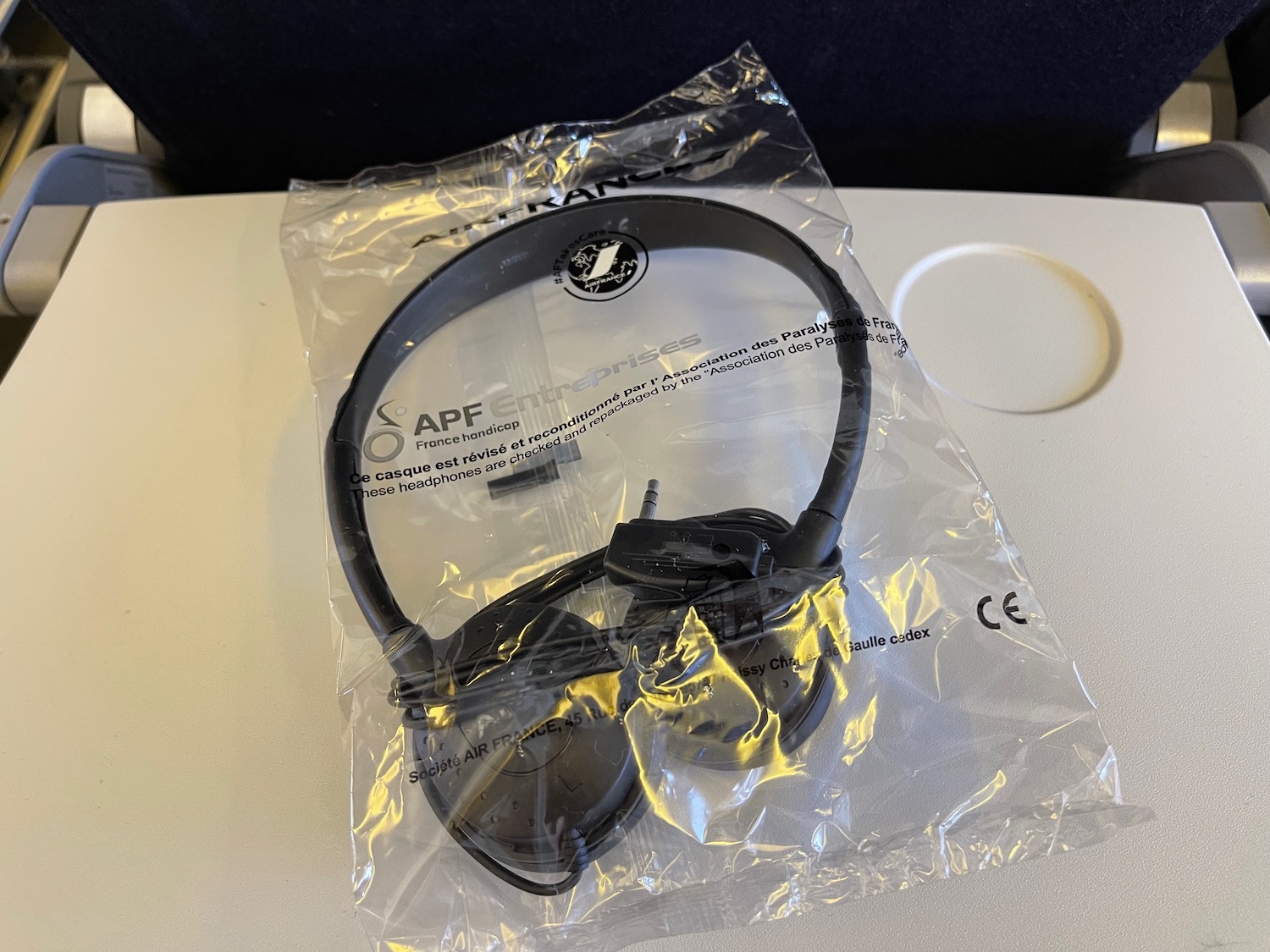 a black headphones in a plastic bag