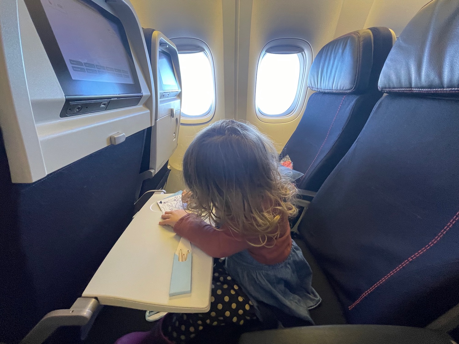 a child sitting on a plane