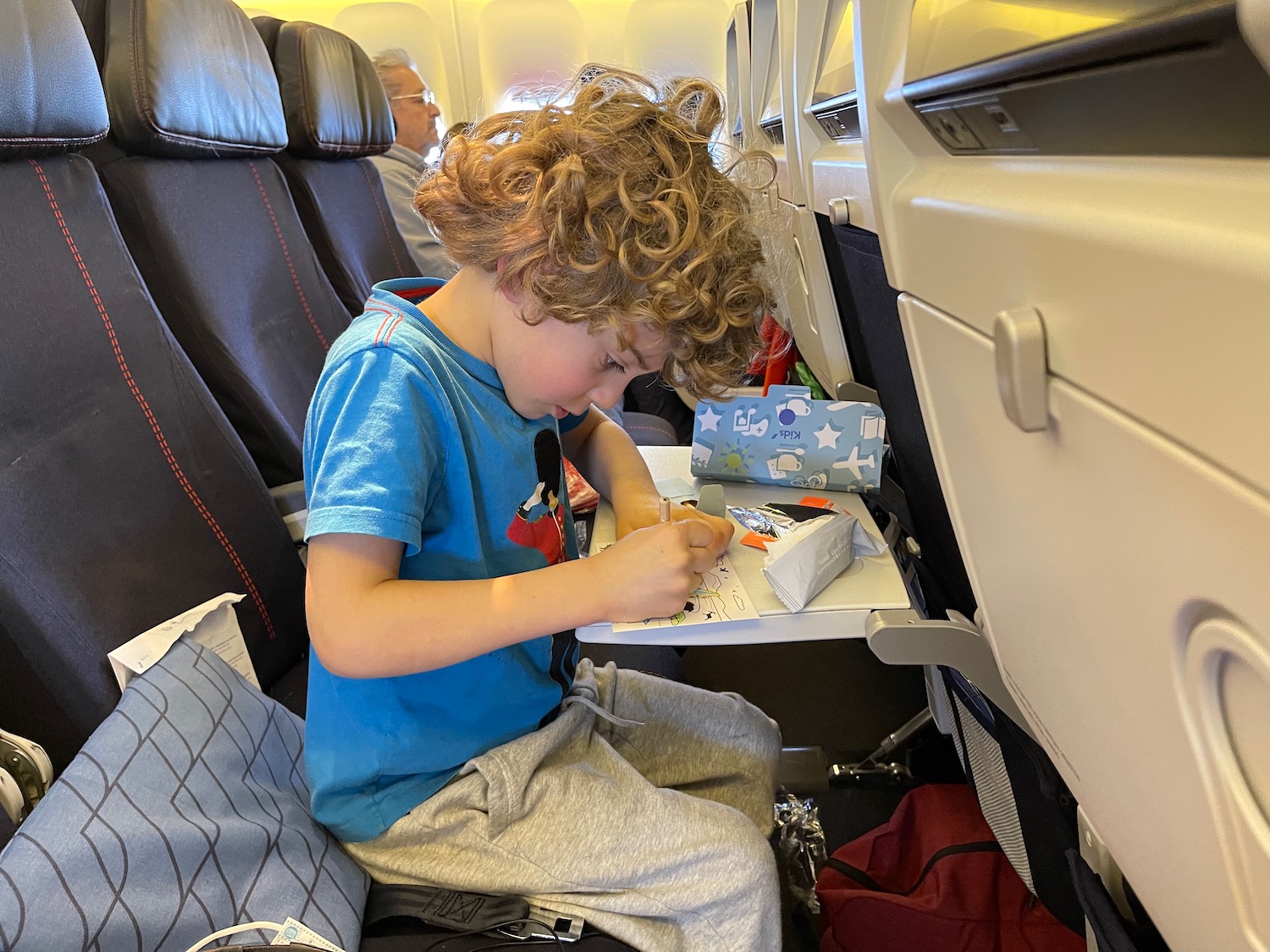 a boy sitting on an airplane