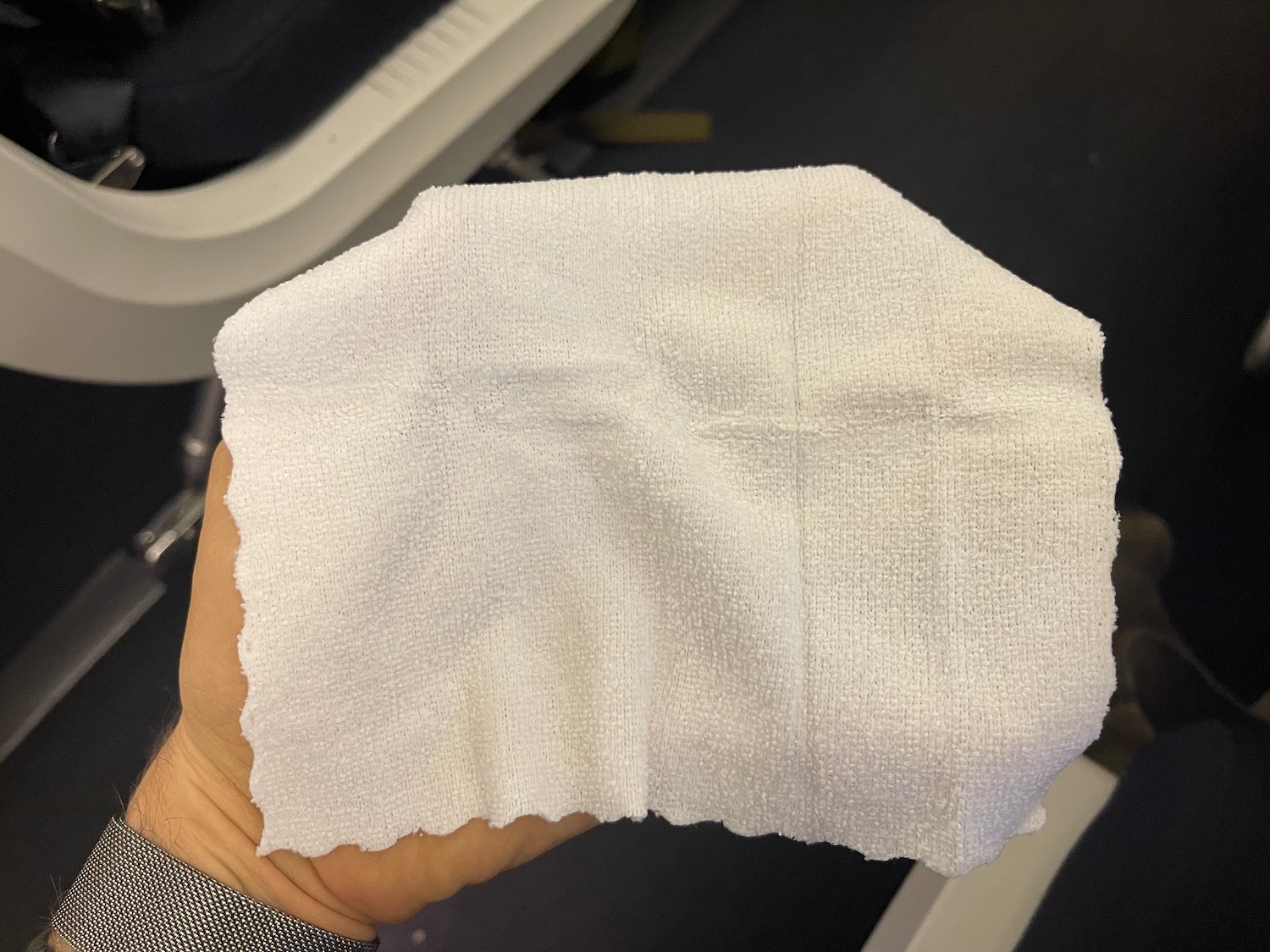 a hand holding a white tissue