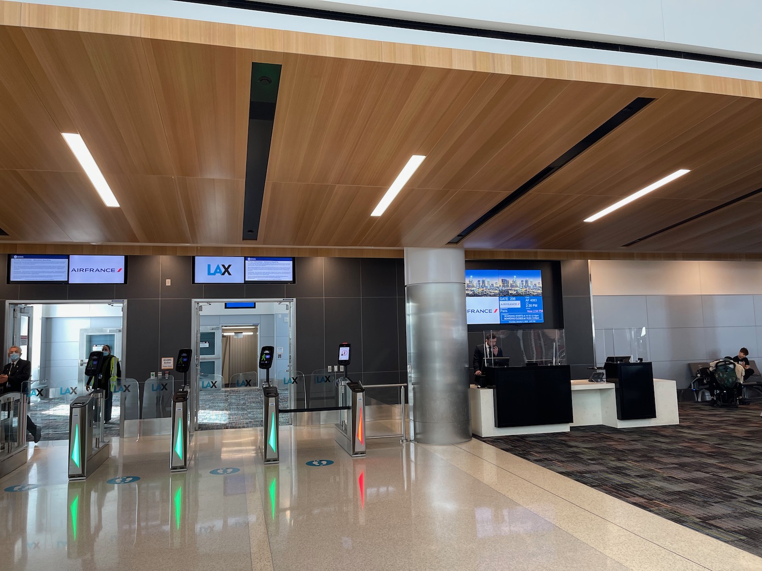 a large airport terminal with a few people standing around