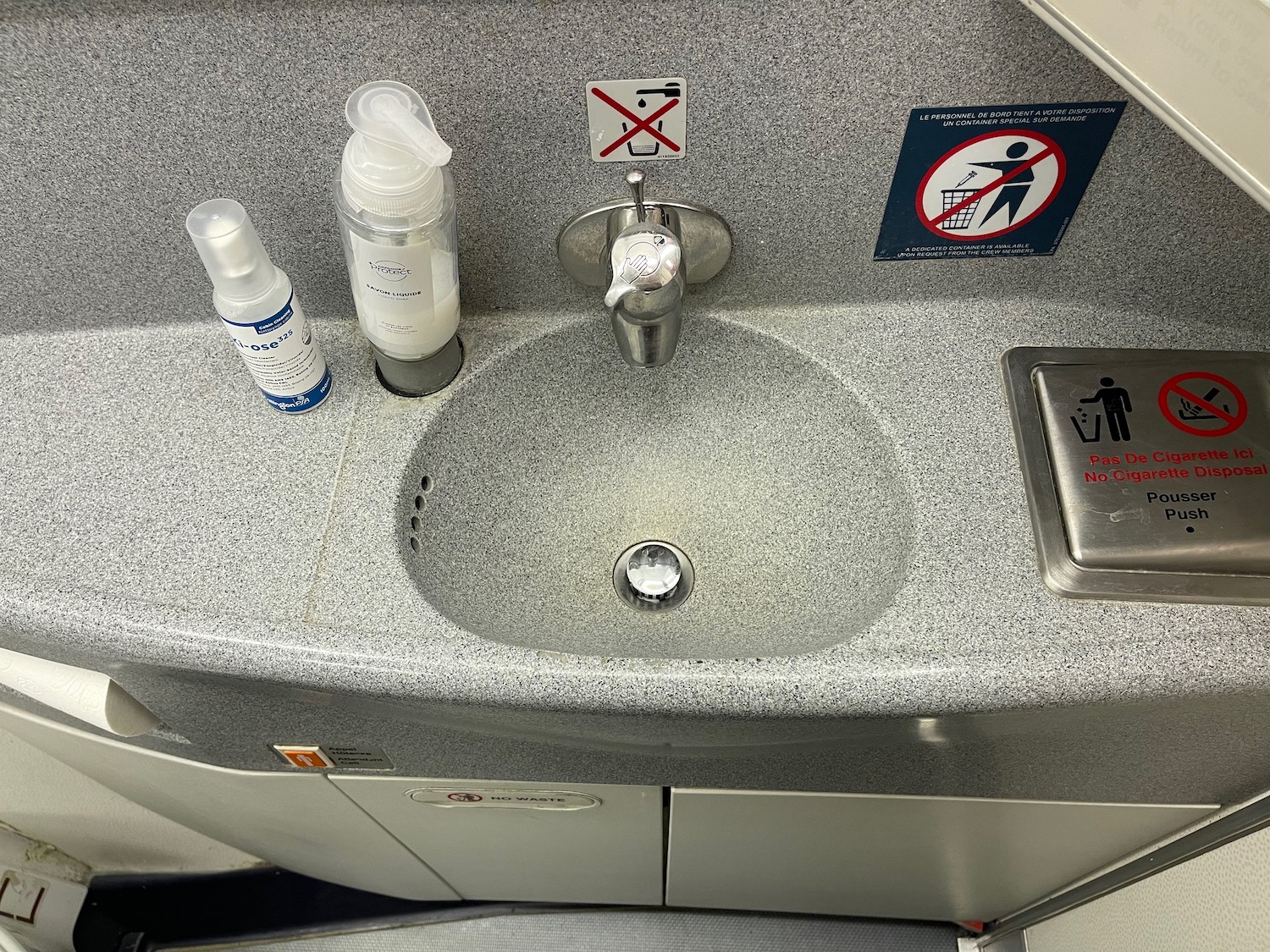 a sink with a faucet and a sign