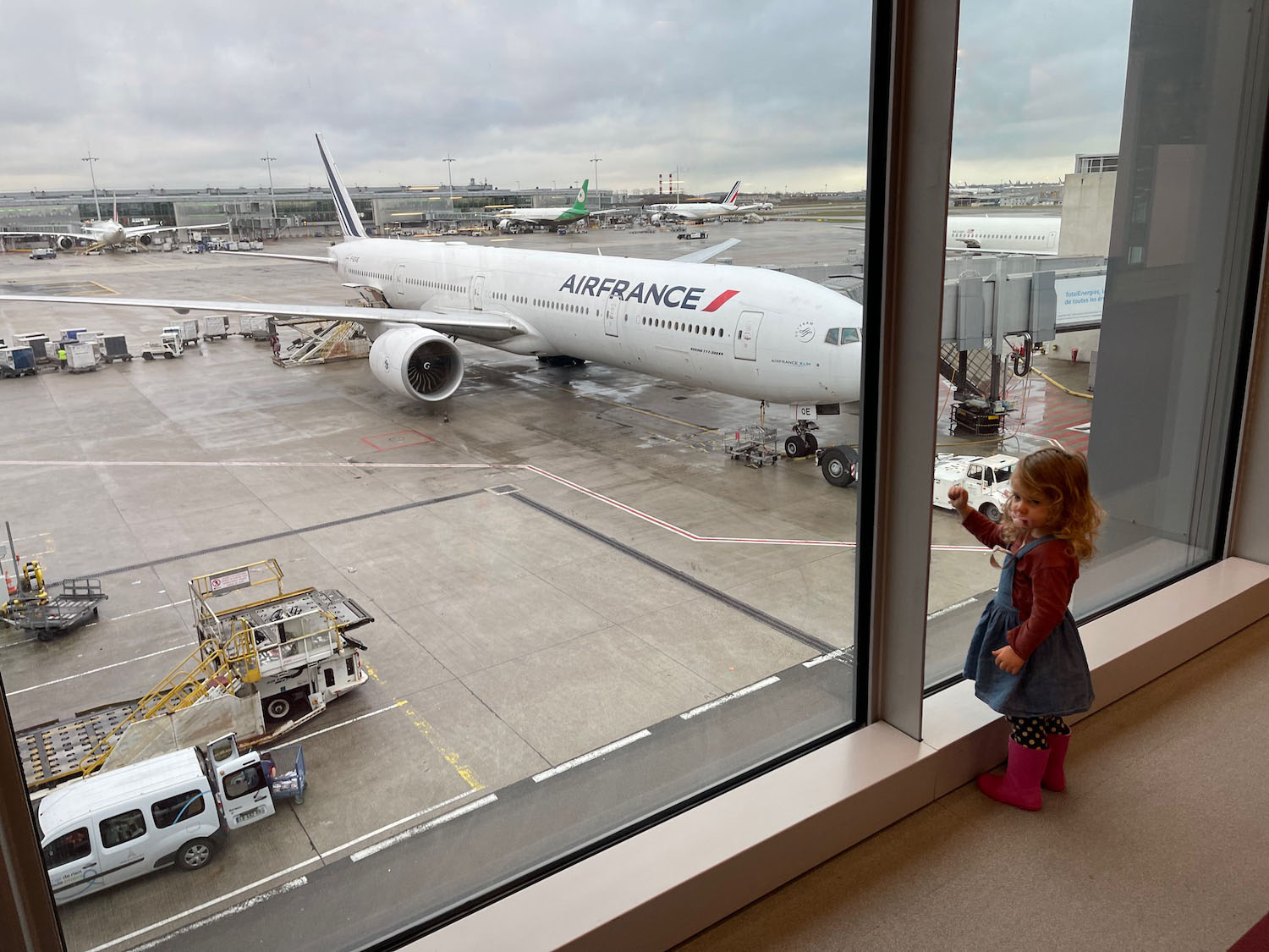 a child looking out a window at an airplane