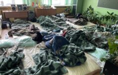 a group of people lying on a bed
