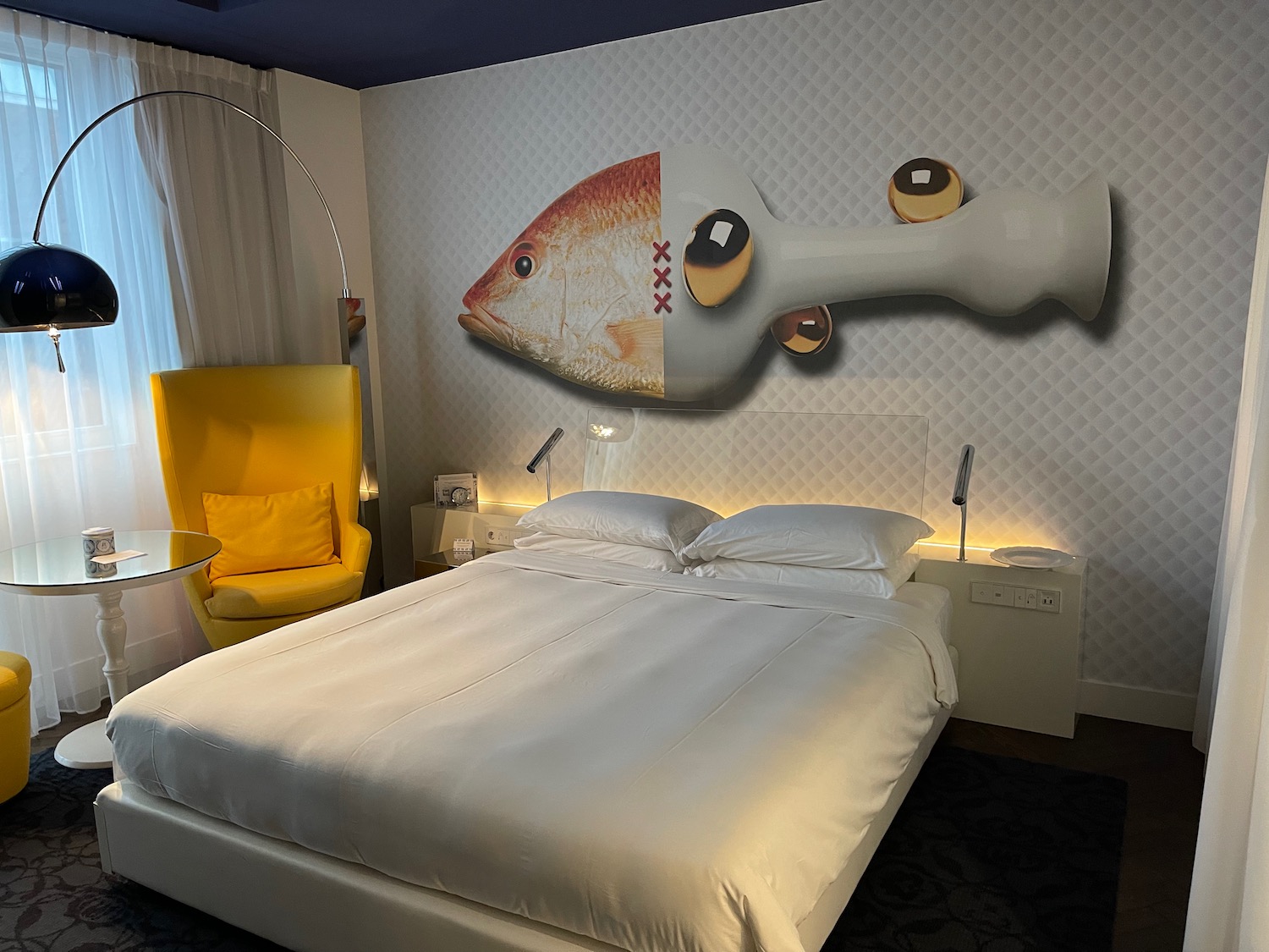 a bed with a fish mural on the wall